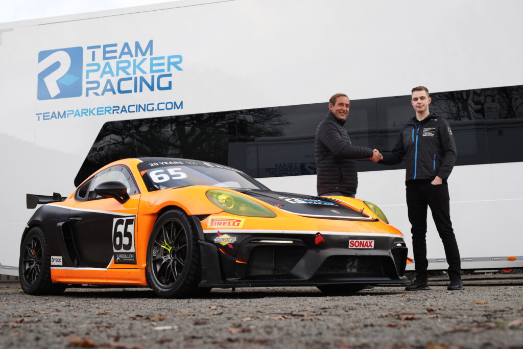 Zac Meakin and Stuart Parker shaking hands and stood beside a Porsche
